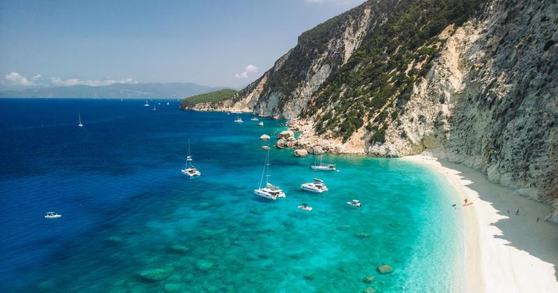 White limestone cliffs and turquoise waters along the coastline of Ithaca, Greece.